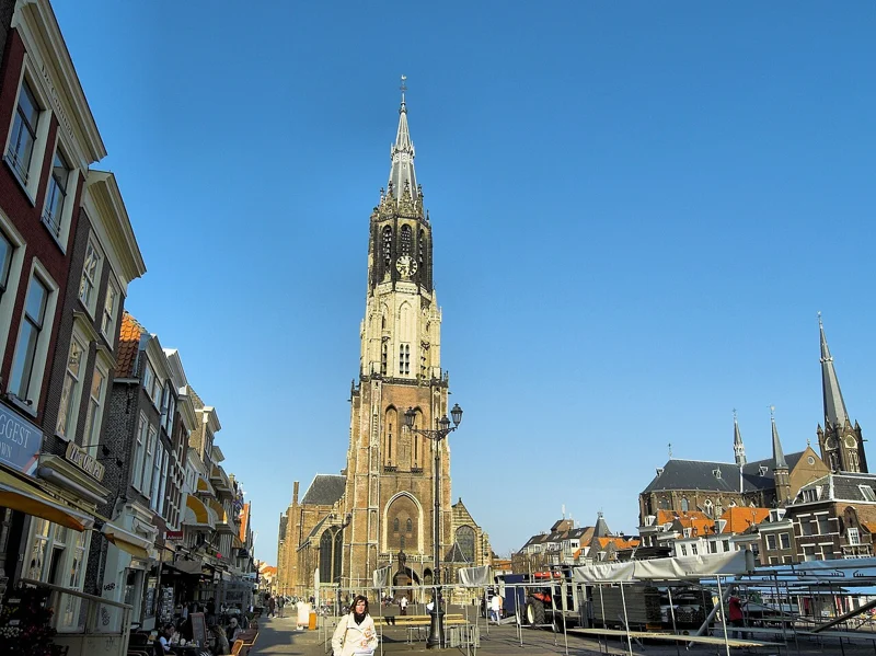 Delft’s Markt square with the Nieuwe Kerk tower beyond the buildings