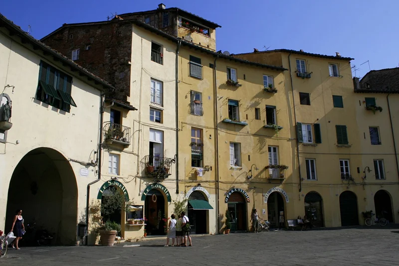 Piazza dell’Anfiteatro in Lucca seen through one of its arched entrances