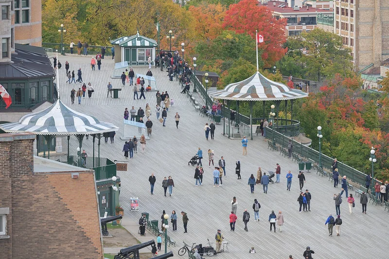 Autumn trees and people walking along Dufferin Terrace in Québec City