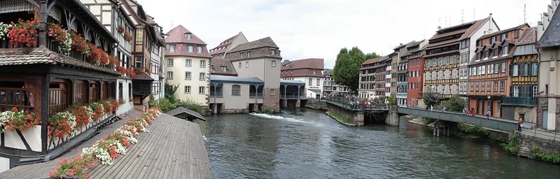 A bridge and half-timbered buildings beside the waterways of Petite France in Strasbourg