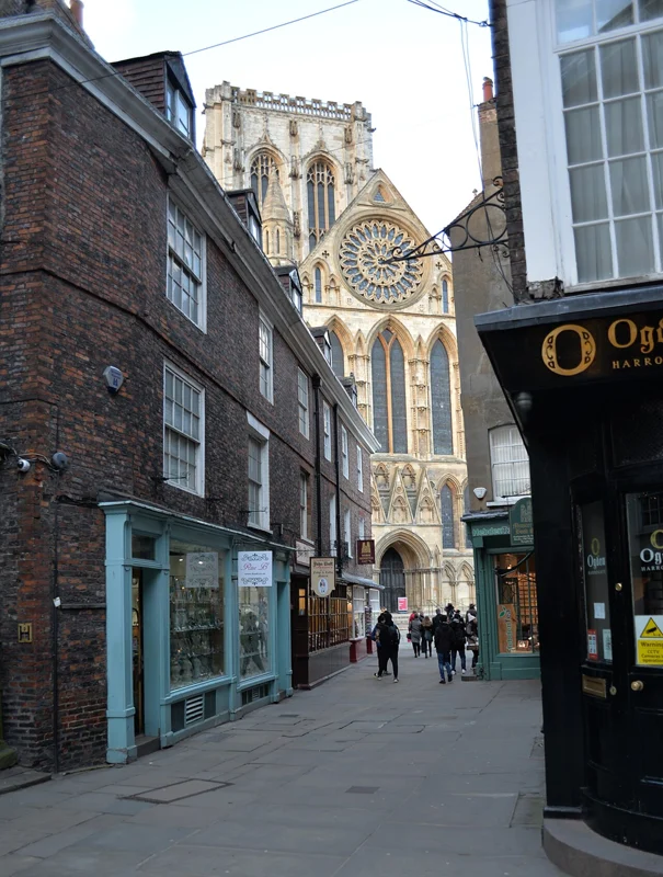 York Minster rising above the buildings along Minster Gates